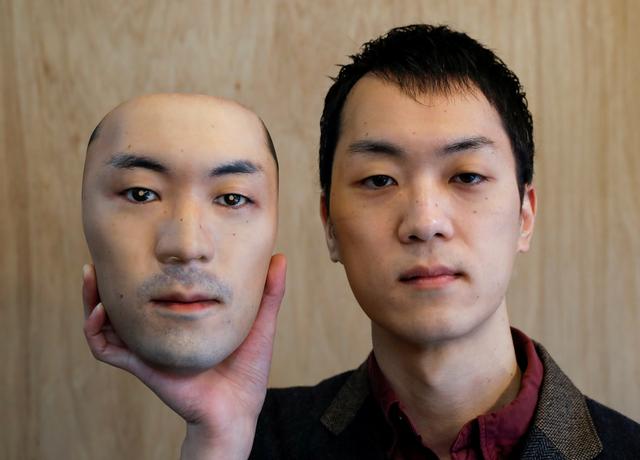 Shuhei Okawara, 30, owner of mask shop Kamenya Omote, holds a super-realistic face mask based on his real face, made by using 3D printing technology, in Tokyo, Japan December 16, 2020. REUTERS